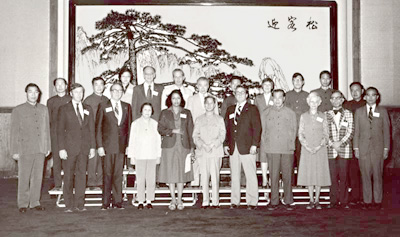UMN delegation posing with Chinese officials in front of large painting