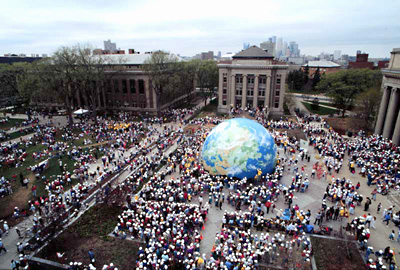 People assemble a large globe on the Northrop Mall