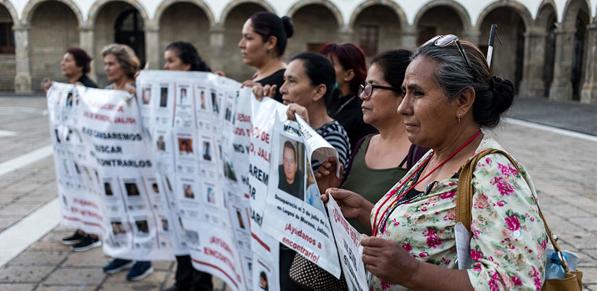 Family members of the disappeared hold a sign