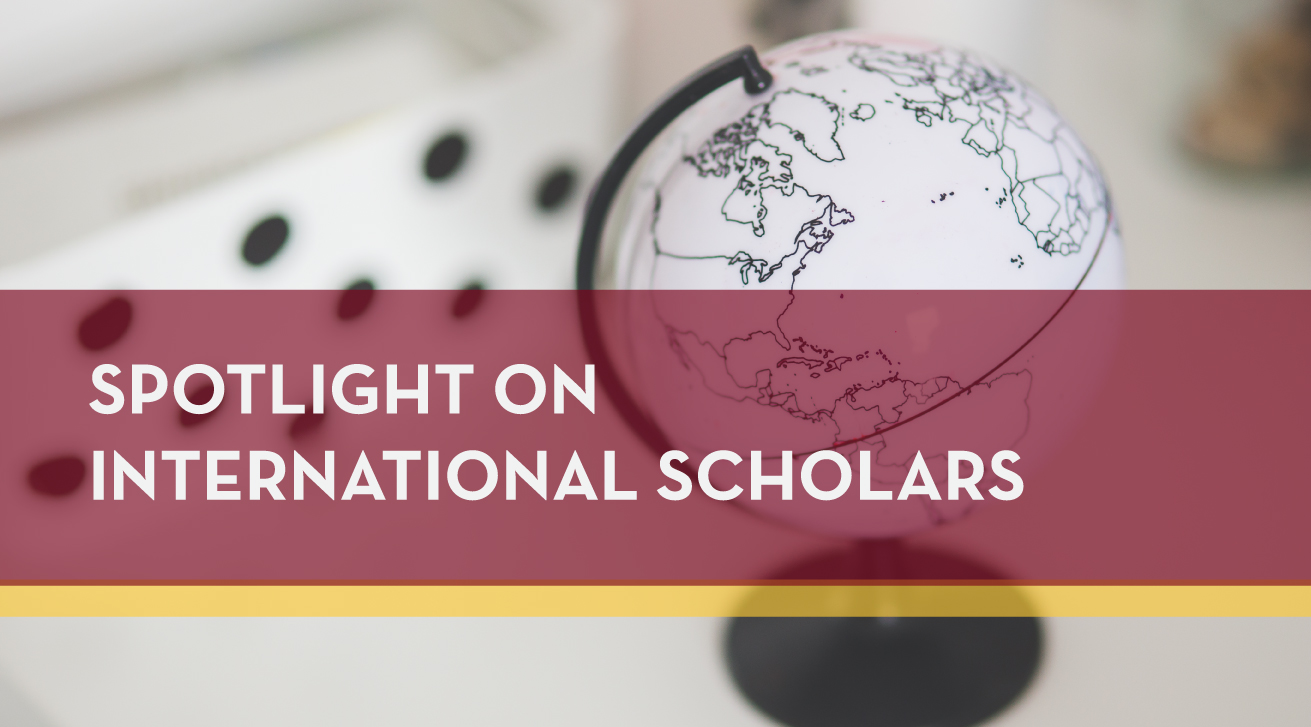 Globe with text "Spotlight on International Scholars"