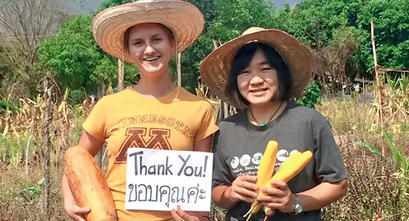 Catlyn Christie with a Thai woman in a field of crops