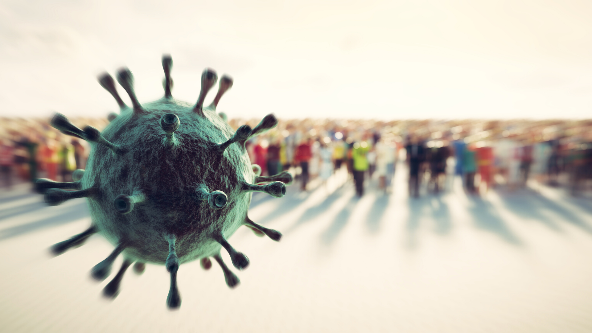 COVID-19 virus in front of a blurred crowd of people