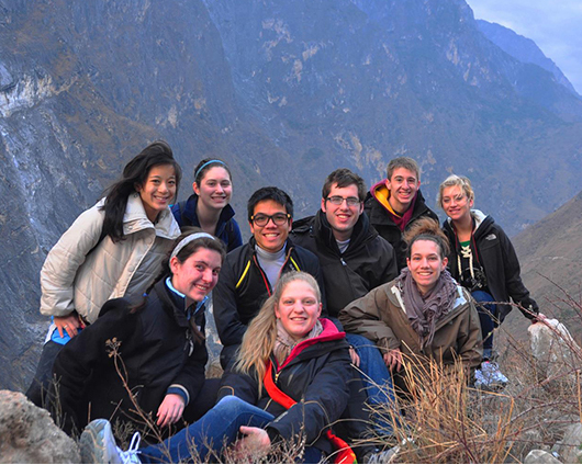 students posing in front of a mountain in China