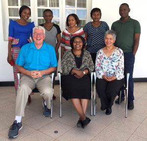 SPH faculty Simon Rosser (front-left) and Zobeida Bonilla (front-right) with their Tanzanian colleagues.