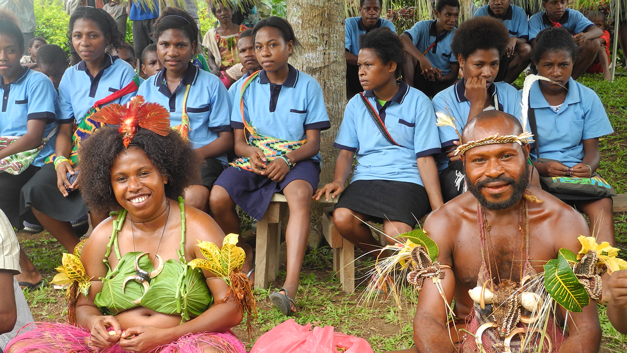 Papua New Guinean students in school uniforms and traditional costumes. Photo: George Weiblen