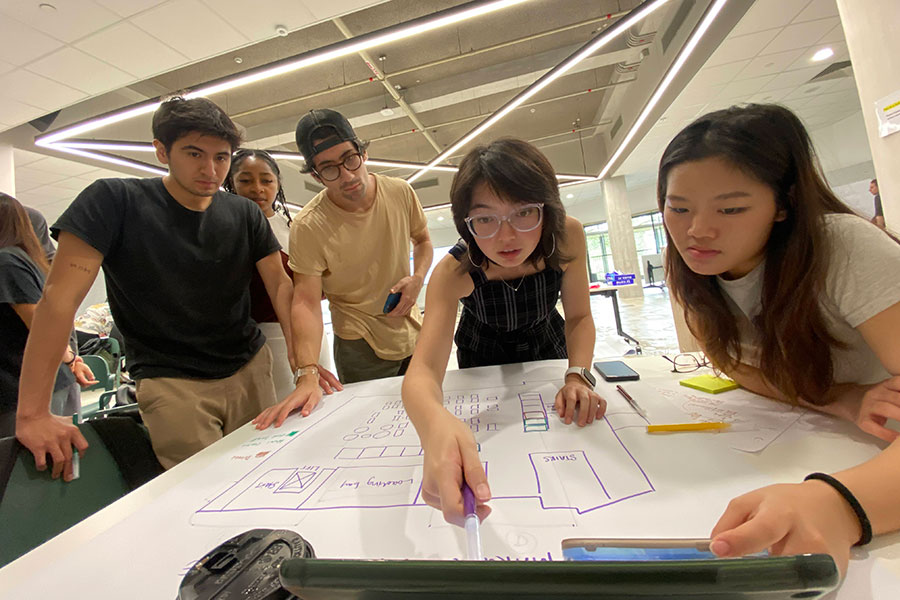 Students looking at plans for a hawker center