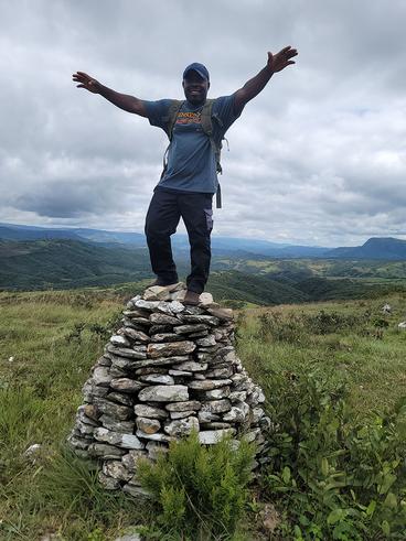 Nick standing on a rock beacon on the Zimbabwe and Mozambique border