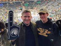 Bolli at a Timberwolves game with another man wearing a Timberwolves foam finger